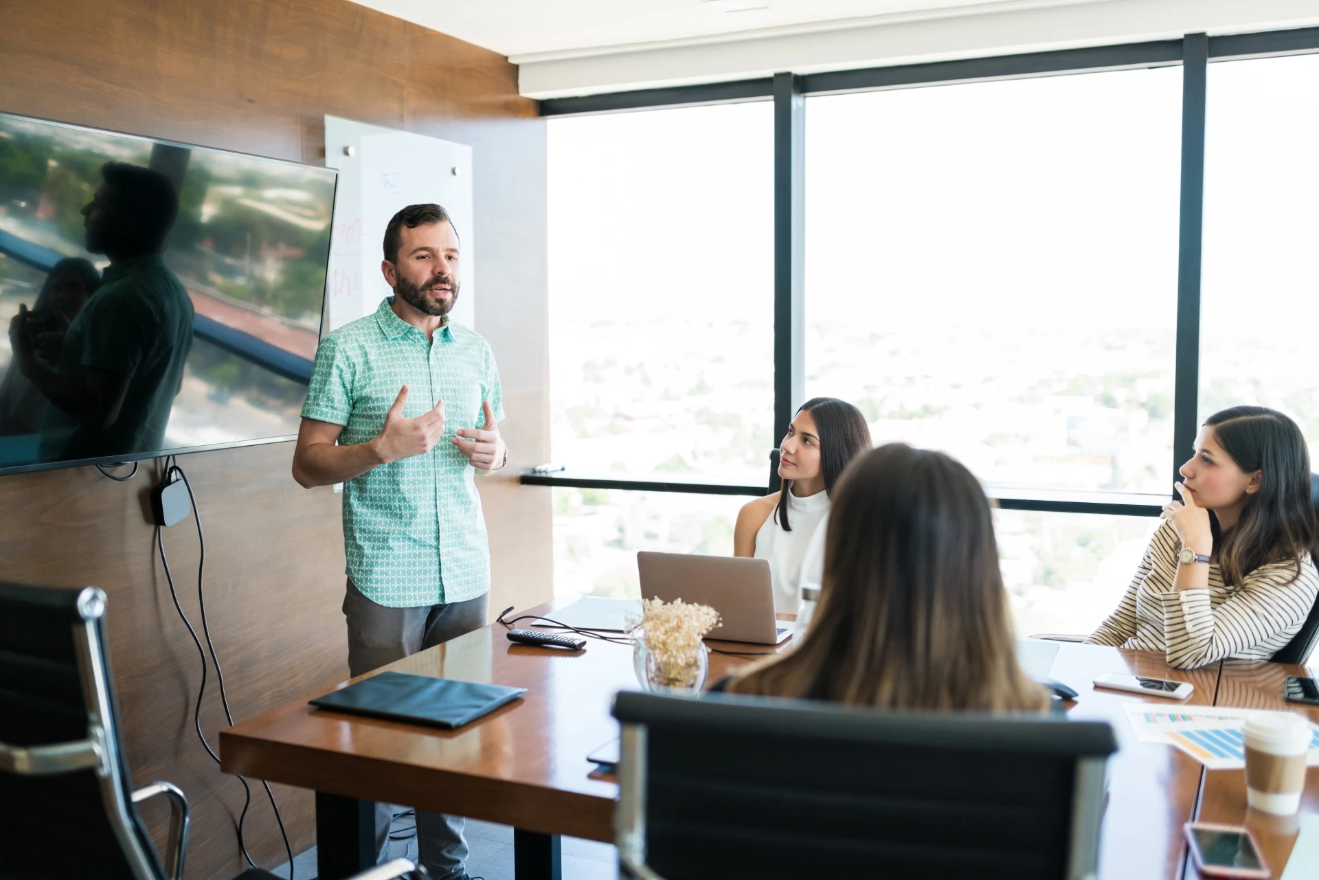 hispanic-manager-sharing-ideas-with-team-meeting-room-office