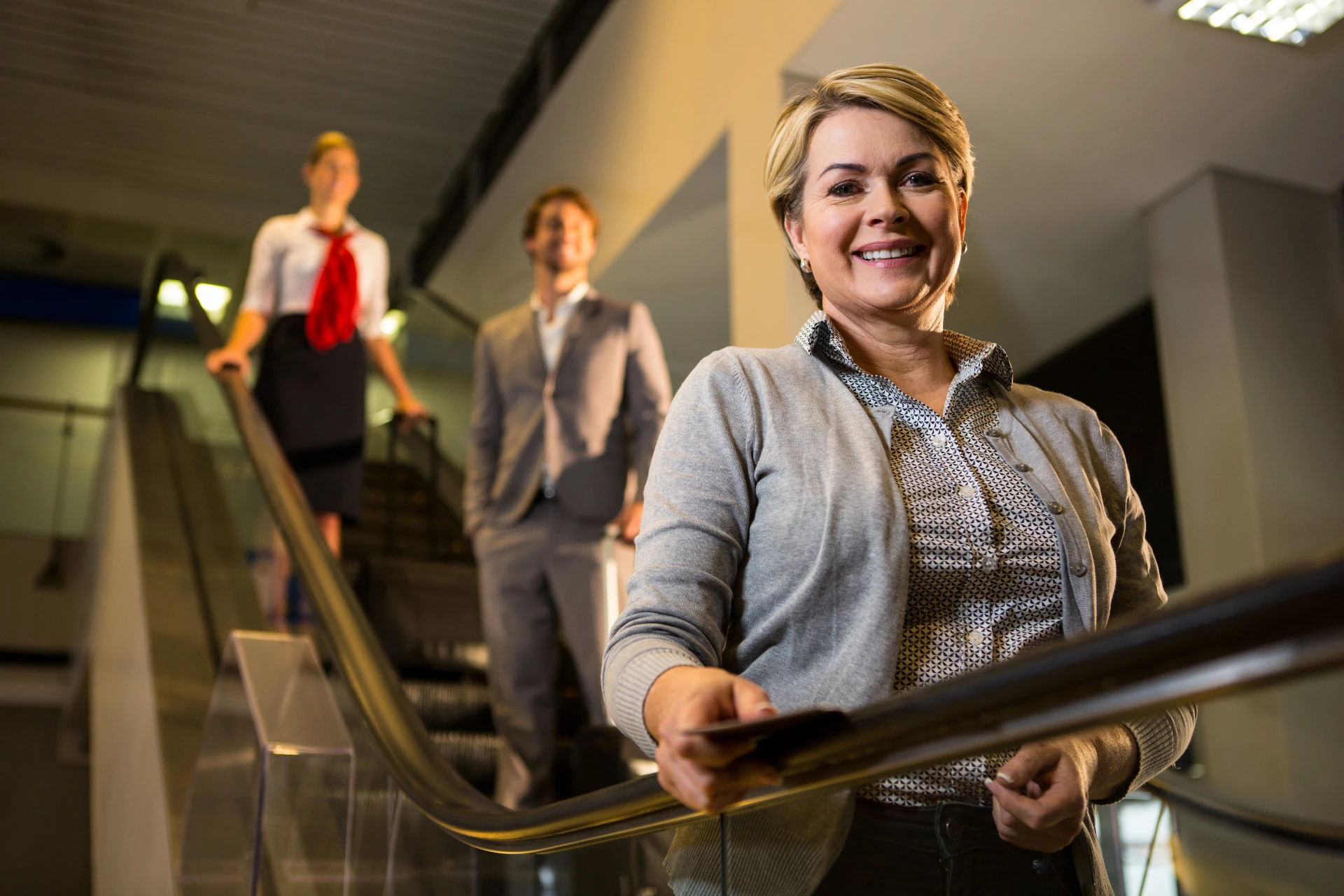 businesswoman-with-boarding-pass-standing-escalator