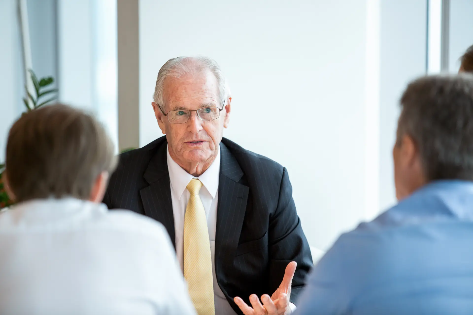 Businessman in formalwear telling a colleague about a contract